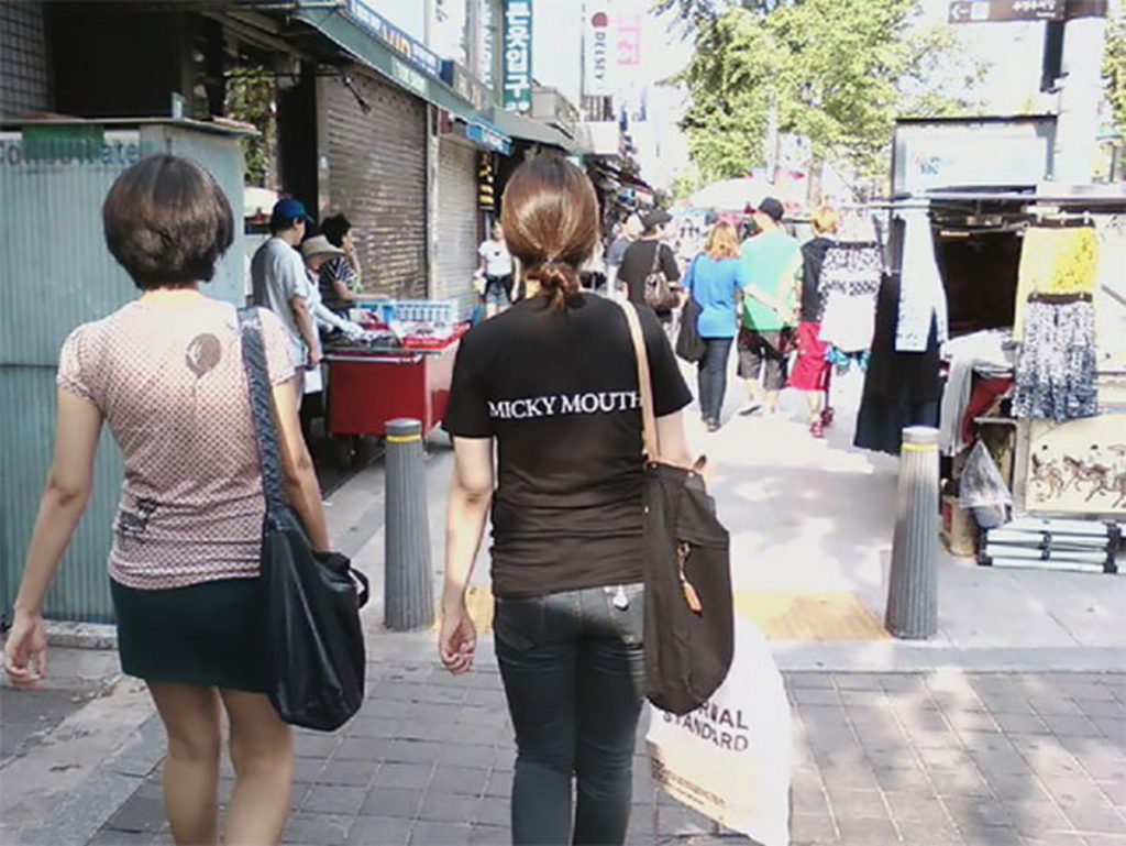 Worst english. Chinese wearing Bad English y Shirt.